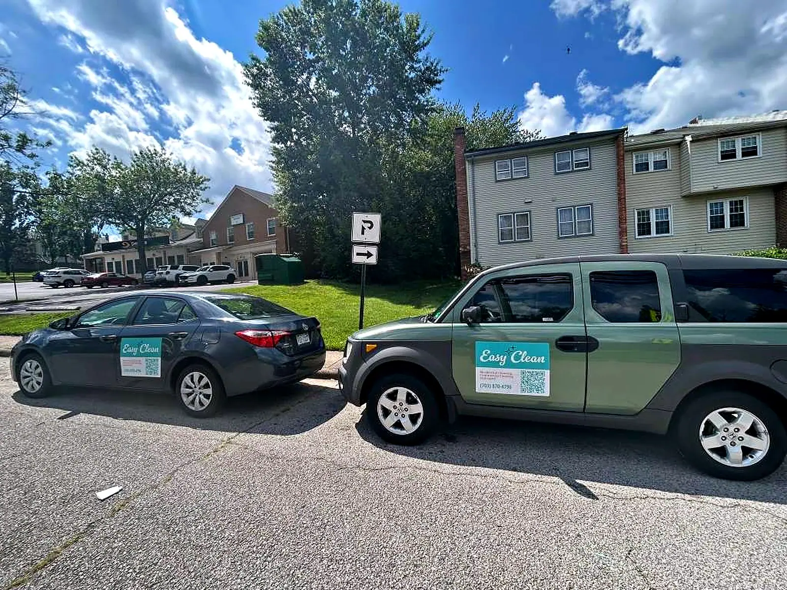 Easy Clean DMV branded vehicles parked outside a townhome community