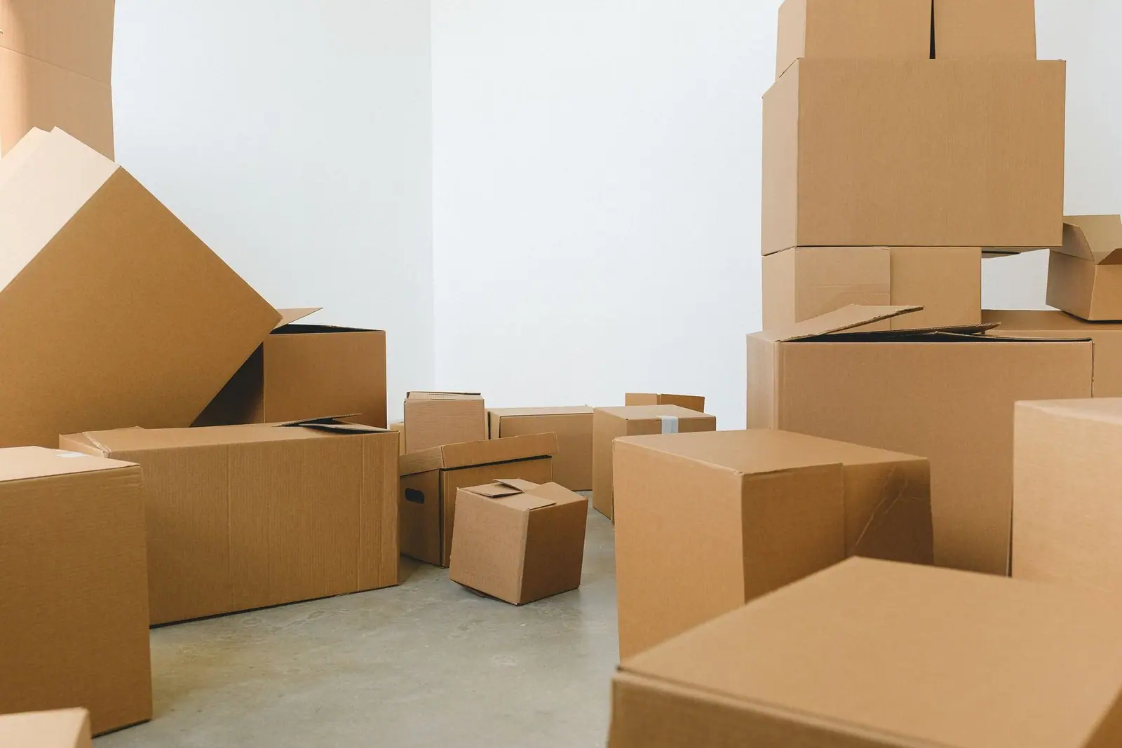Cardboard boxes stacked in a bright, empty room