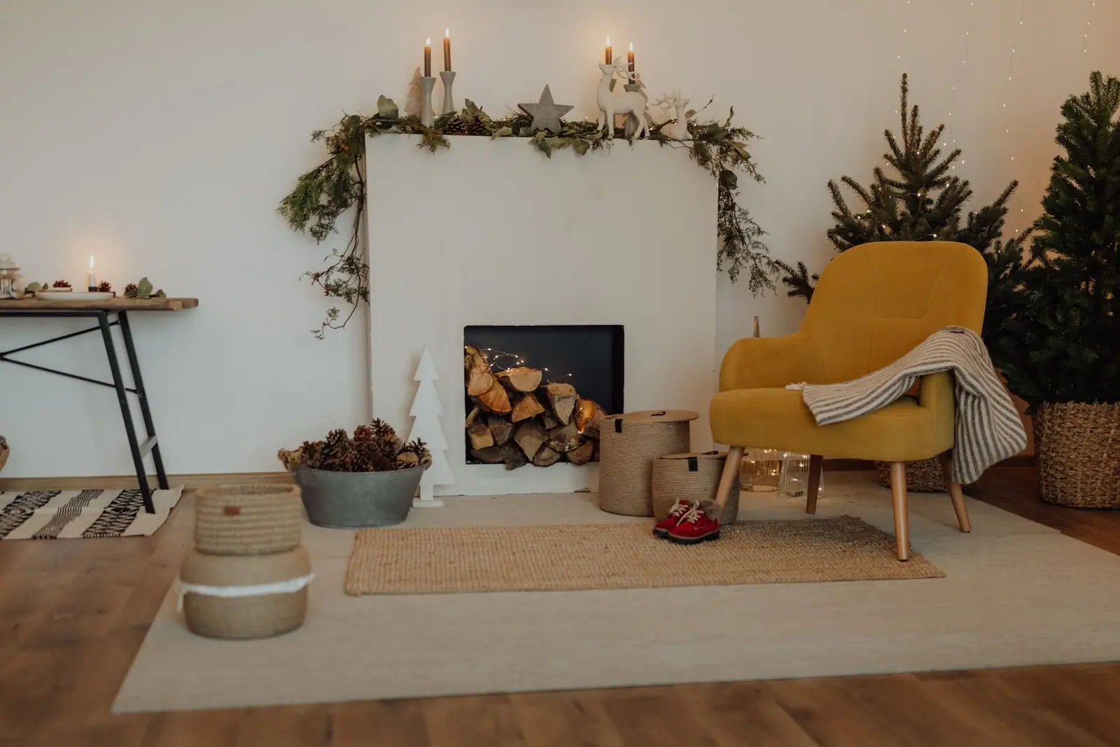Living room decorated for the holidays with a fireplace, garland and a yellow armchair
