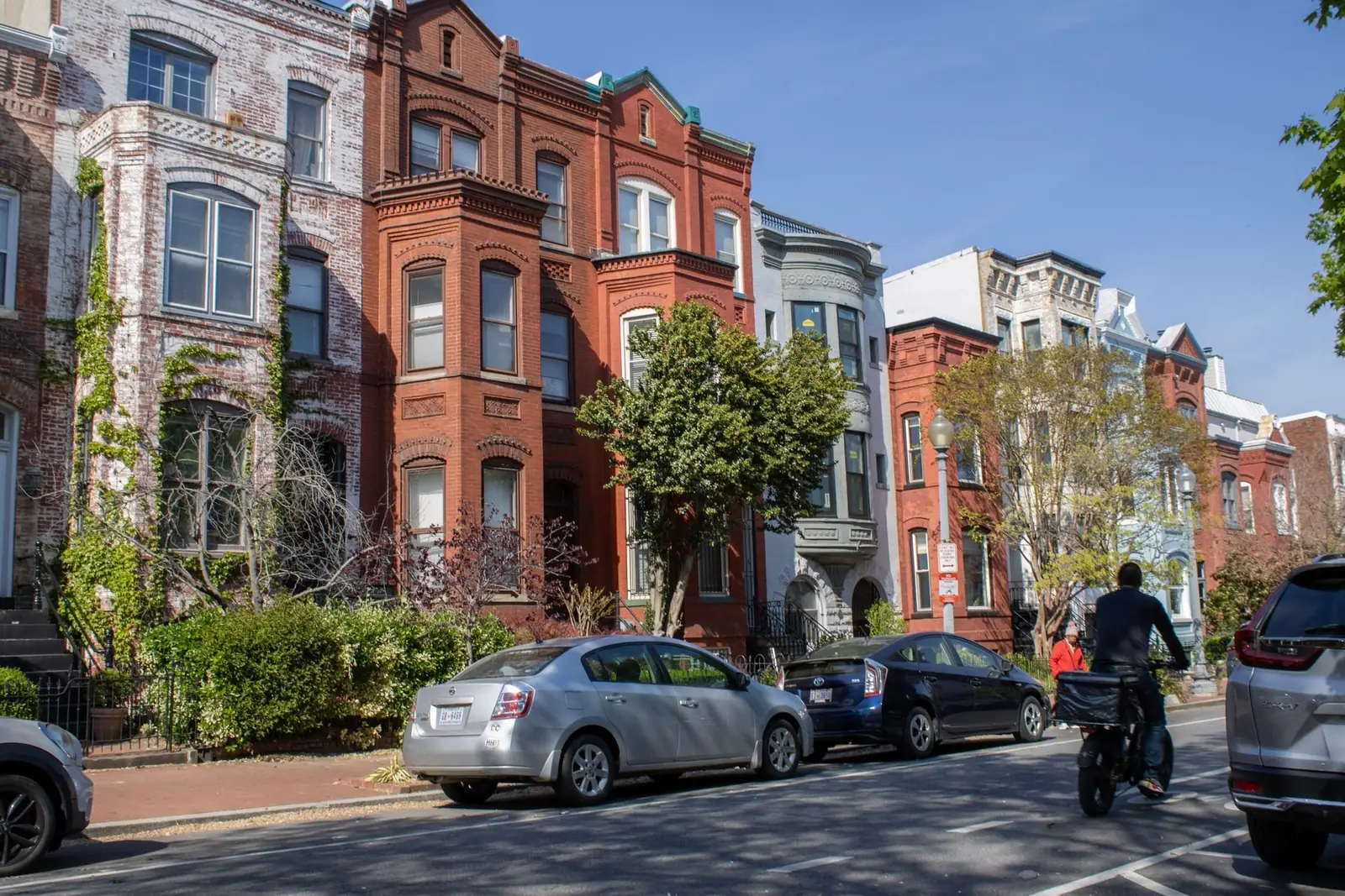 Brick row houses on a sunny street in Washington, D.C.